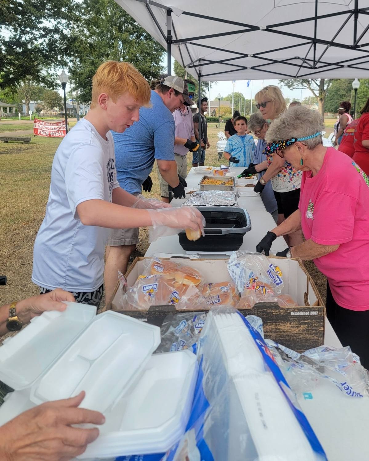 Volunteers serving a community meal at Come to the Table